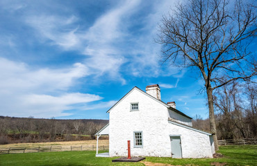 Obraz premium 19th Century House and the Mountains of Pennsylvania From Hopewell Furnace National Historic Site