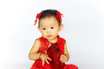 Chinese New Year festival concept, a Chinese 's baby girl in the red clothes. She holding a pocket money gift in her hand. On white background.