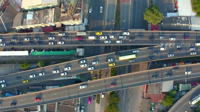 Top view of elevated expressway. Beautiful aerial shot of the curve of suspension bridge in daytime in Bangok, Thailand. Scenic road, big city life and transportation concept.