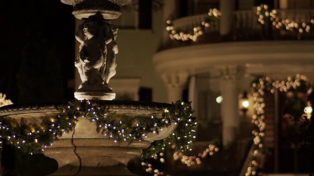 Holiday lights on a beautiful fountain...nice porch in the distance.  Shot on BMC Cinema 4K with f.1.5.22  prime cine lens. Rendered in Apple ProRes 422.  No color correction/grading done.