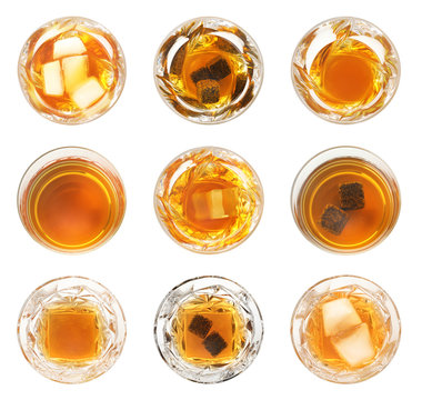 Set of glasses with expensive whiskey on white background, top view