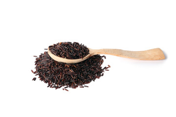 Spoon and uncooked black rice on white background