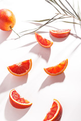 Composition of Sicilian oranges, whole and cut on a white background.