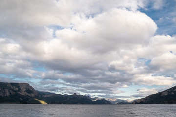 clouds over the sea lake mountains