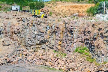 View of quarry open pit mining of granite stone. Process production stone and gravel. Quarry mining equipment.