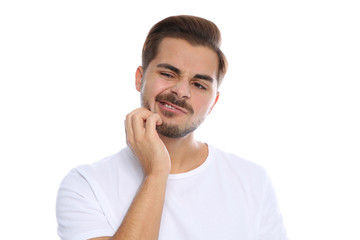 Young man scratching face on white background. Annoying itch