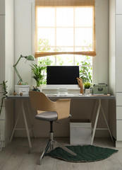 Light work place with computer near window at home. Interior design