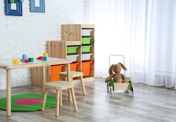 Modern child room interior with table and stools