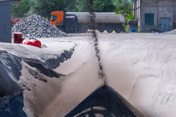 Crushing machinery, cone type rock crusher, conveying crushed granite gravel stone in a quarry open pit mining. Processing plant for crushed stone and gravel. Mining and Quarry mining equipment.
