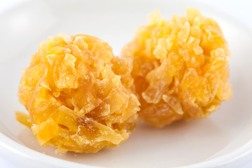 Colombian traditional papaya sweet called caballito in a white ceramic dish