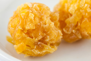 Colombian traditional papaya sweet called caballito in a white ceramic dish