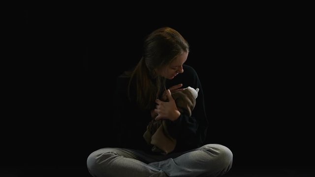 Wretched woman hugging toy imagining baby, obstetric violence victim, depression