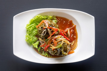 stuffed peppers, paprika on a white plate on a dark background