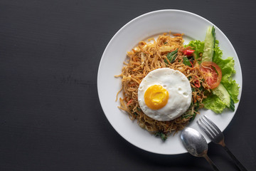 Asian dish fried noodles with egg and seafood or beef or chicken
