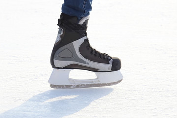 Feet skating on the ice rink