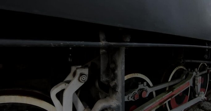 Close up view of narrow track coal train, with the camera focused on the lower part of the train.