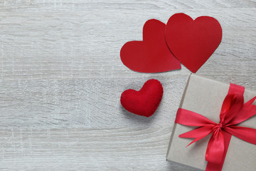 Gift box and red paper heart shape on wooden floors and have copy space.