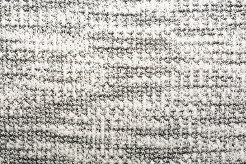 The texture of the knitted gray fabric for the background