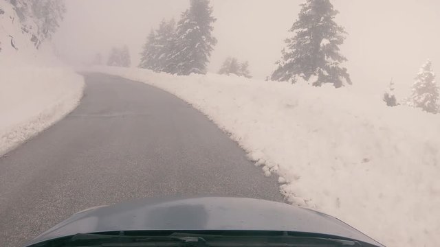 Driving through the fog on a snowy mountain road to Ziria ski center in Greece.