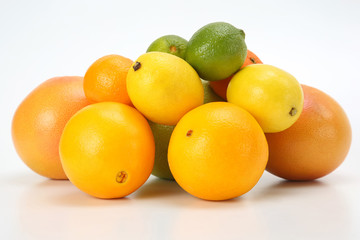 different citrus fruits on white background