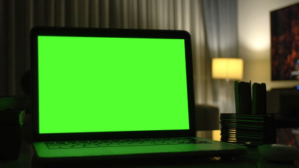 Laptop with green screen for replacement with blur background