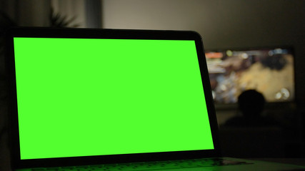 Laptop with green screen for replacement with blur background