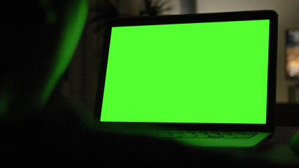 Laptop with green screen for replacement with blur background