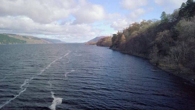 Aerial footage of Loch Ness looking towards Inverness on a sunny day, Scottish Highlands, Scotland