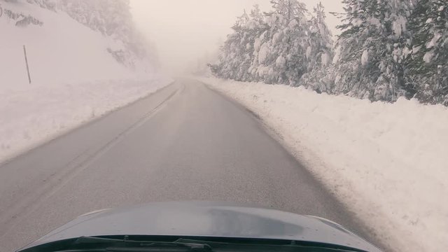 Driving through the fog on a snowy mountain road to Ziria ski center in Greece.