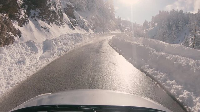 Driving on a snowy mountain road, sunny weather. Approaching Ziria ski center in Greece.