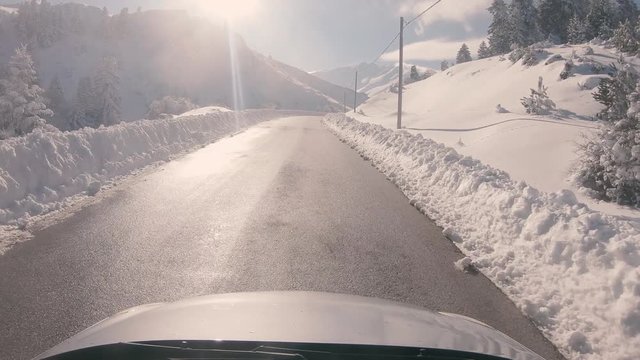 Driving on a snowy mountain road, sunny weather. Approaching Ziria ski center in Greece.