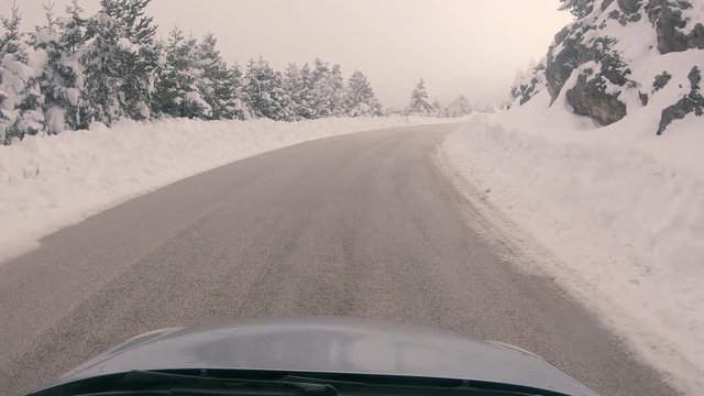 Driving through the fog on a snowy mountain road to Ziria ski center in Greece.