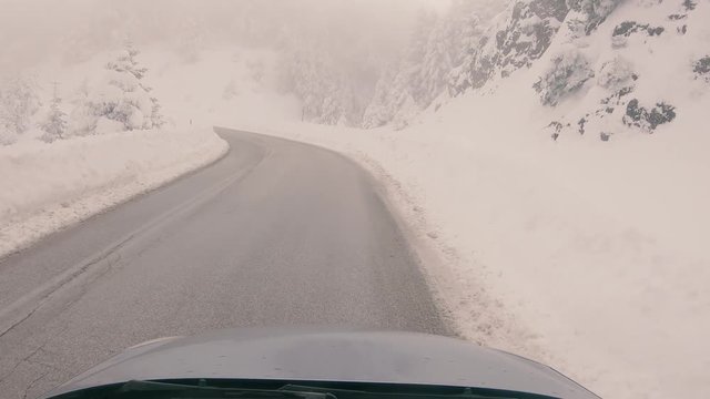 Driving through the fog on a snowy mountain road to Ziria ski center in Greece.