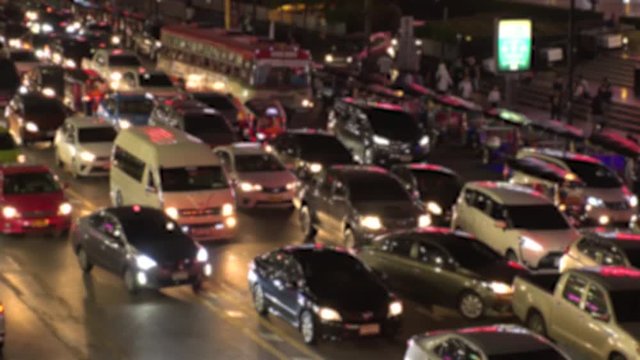 BANGKOK,  THAILAND - CIRCA OCTOBER 2018 : Blurred view of HEAVY RUSH HOUR TRAFFIC JAM near CHIT LOM train station.  Many CAR, BUS, TAXI, MOTORBIKE and TUK TUK on the road.