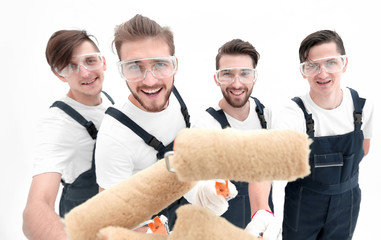 closeup.a team of builders with paint rollers.i