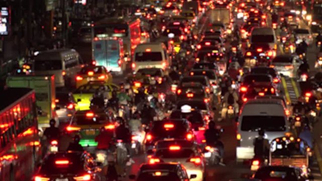 BANGKOK,  THAILAND - CIRCA OCTOBER 2018 : Blurred view of HEAVY RUSH HOUR TRAFFIC JAM near CHIT LOM train station.  Many CAR, BUS, TAXI, MOTORBIKE and TUK TUK on the road.