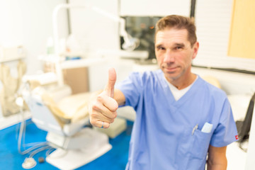 Obraz premium Professional male dentist smiling at camera in office
