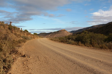 Curved gravel road in the southern Karoo of South Africa.