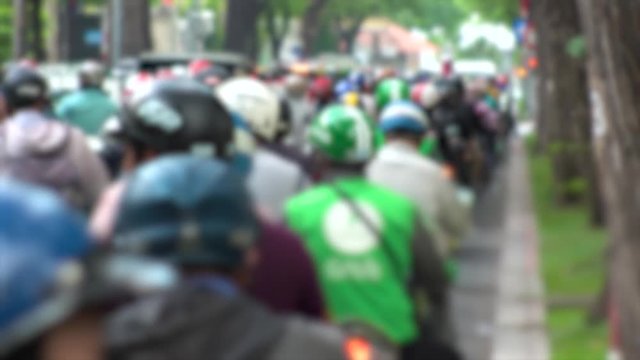 HO CHI MINH,  VIETNAM - CIRCA NOVEMBER 2018 : Blurred view of HEAVY RUSH HOUR TRAFFIC.  Many MOTORBIKE RIDERS on the busy road.