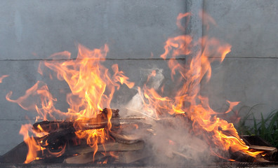 Orange flame burning on a gray background