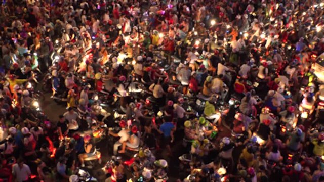HO CHI MINH,  VIETNAM - CIRCA OCTOBER 2018 : Aerial view of CROWD of PEOPLE and MOTORBIKES at BUI VIEN STREET in blurred.