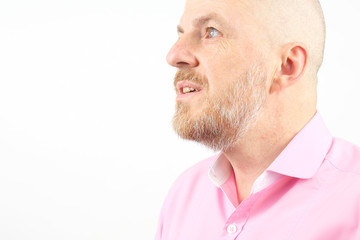Fototapeta premium Studio portrait of a bearded man in a pink shirt