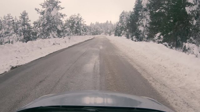 Driving on a snowy mountain road to Ziria ski center in Greece.