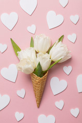 Flat-lay waffle cone with white flower blossom