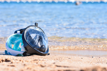 Two masks for snorkeling on the sandy beach near the sea, copy Space