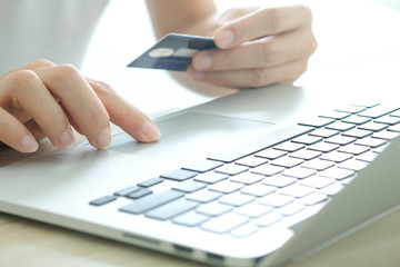 Hand of men modern lifestyle he sit in the living room on sofa , using his computer pc and holding credit card her online To buy product in the internet
