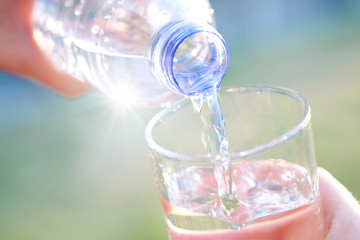Clean water for good health. Pouring Fresh Pure Water From Pitcher Into A Glass on table wooden. Health And Diet Concept. Lifestyle Healthcare And Beauty.