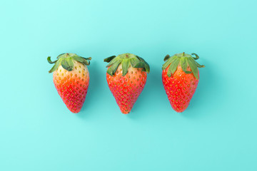 Strawberries on light blue background, flat lay