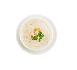 Champignon mushroom cream soup in bowl on white background.  Top view.