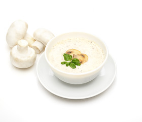 Champignon mushroom cream soup in bowl on white background.  